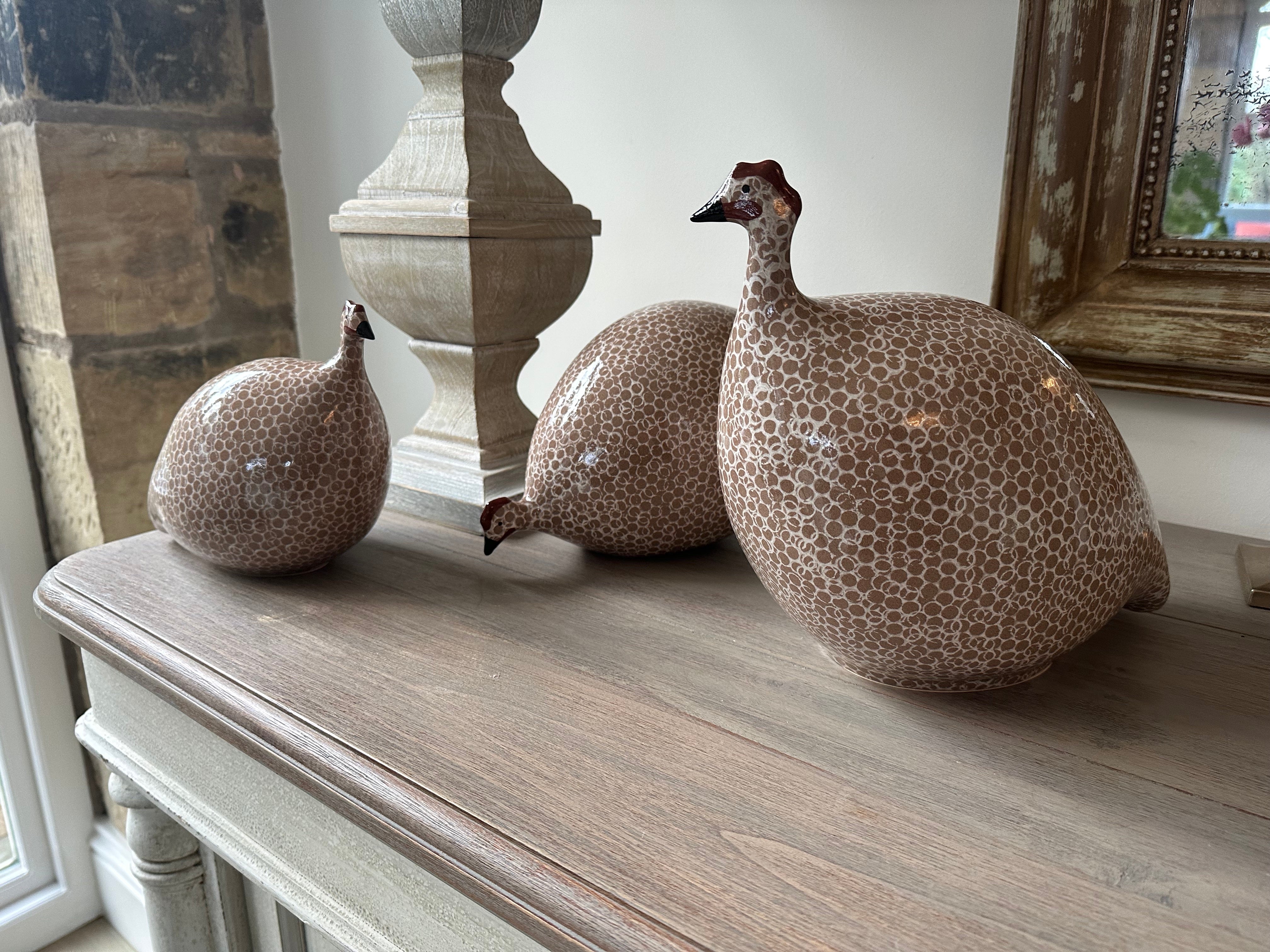 Brown ceramic guinea fowls in various sizes