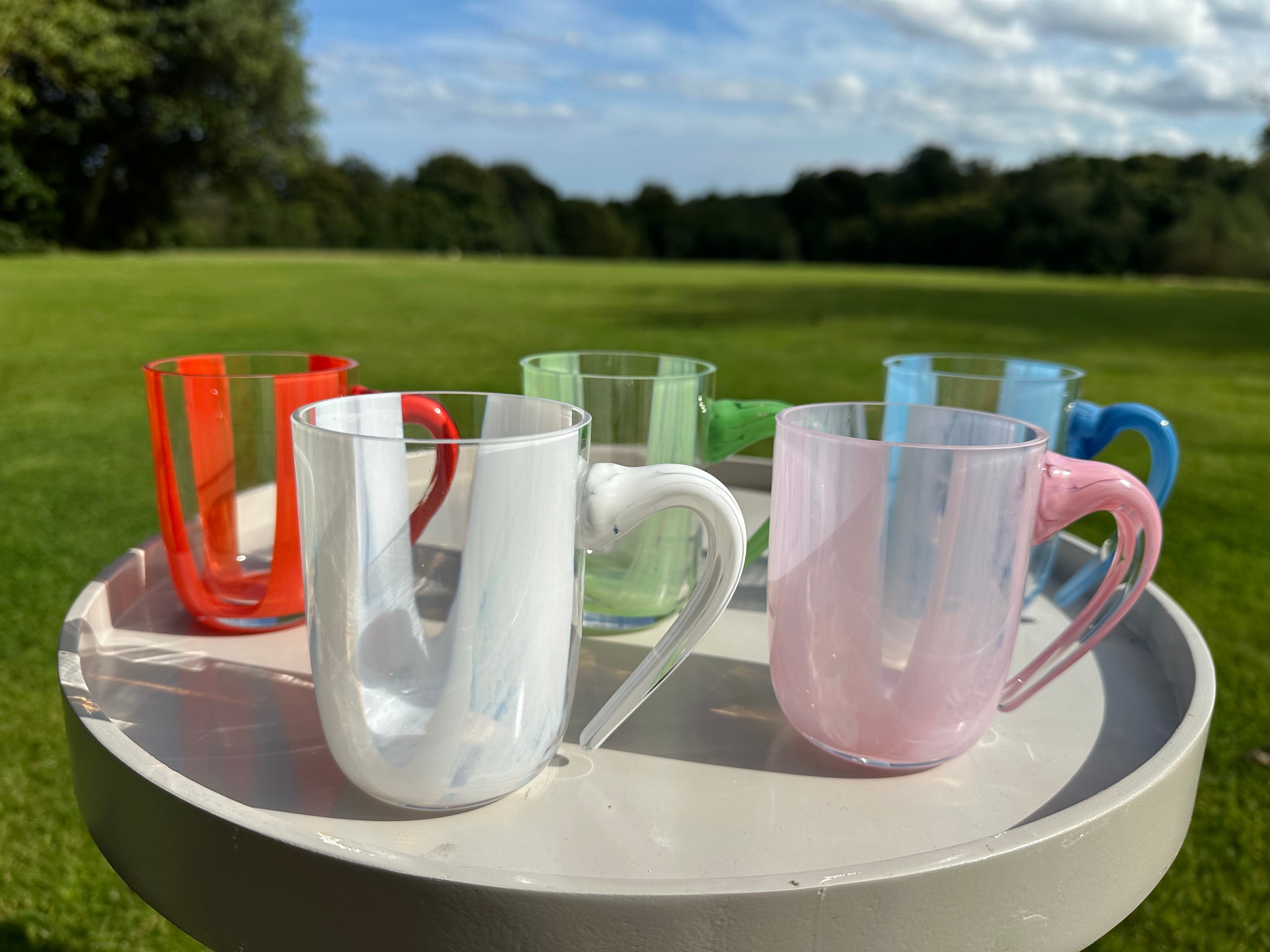 A row of hobnail jugs in two sizes