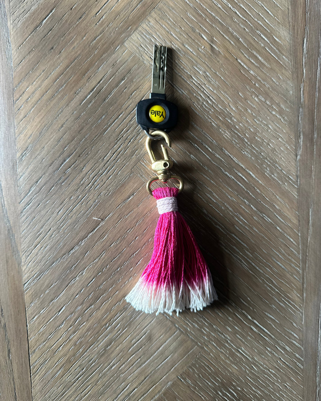 Key ring with a pink tassel
