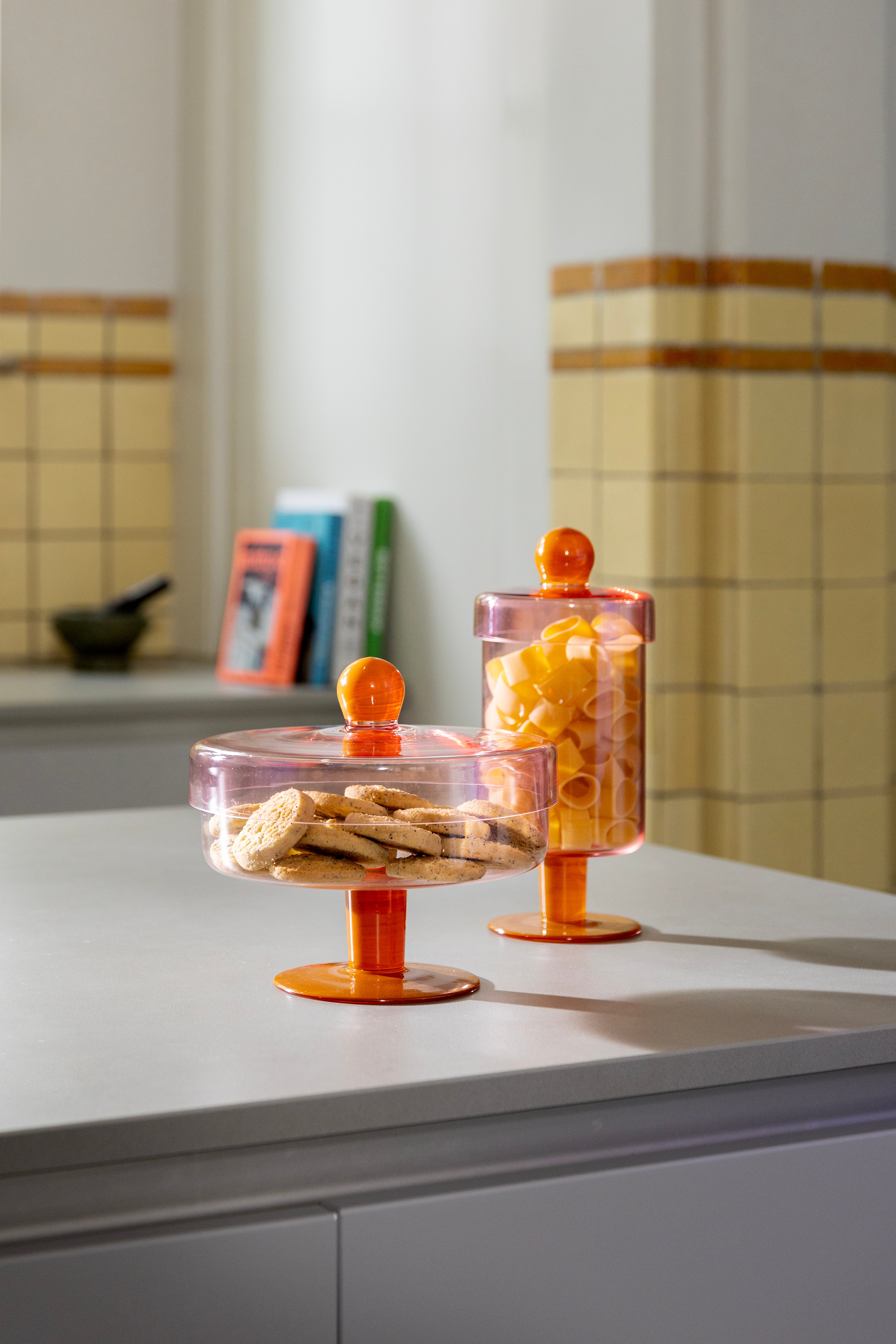 Pink glass storage jar with orange detail