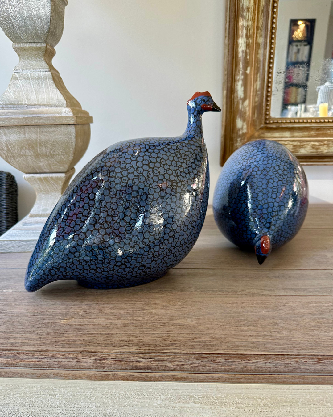 Ceramic electric blue with black spots guinea fowls, one large and one pecking