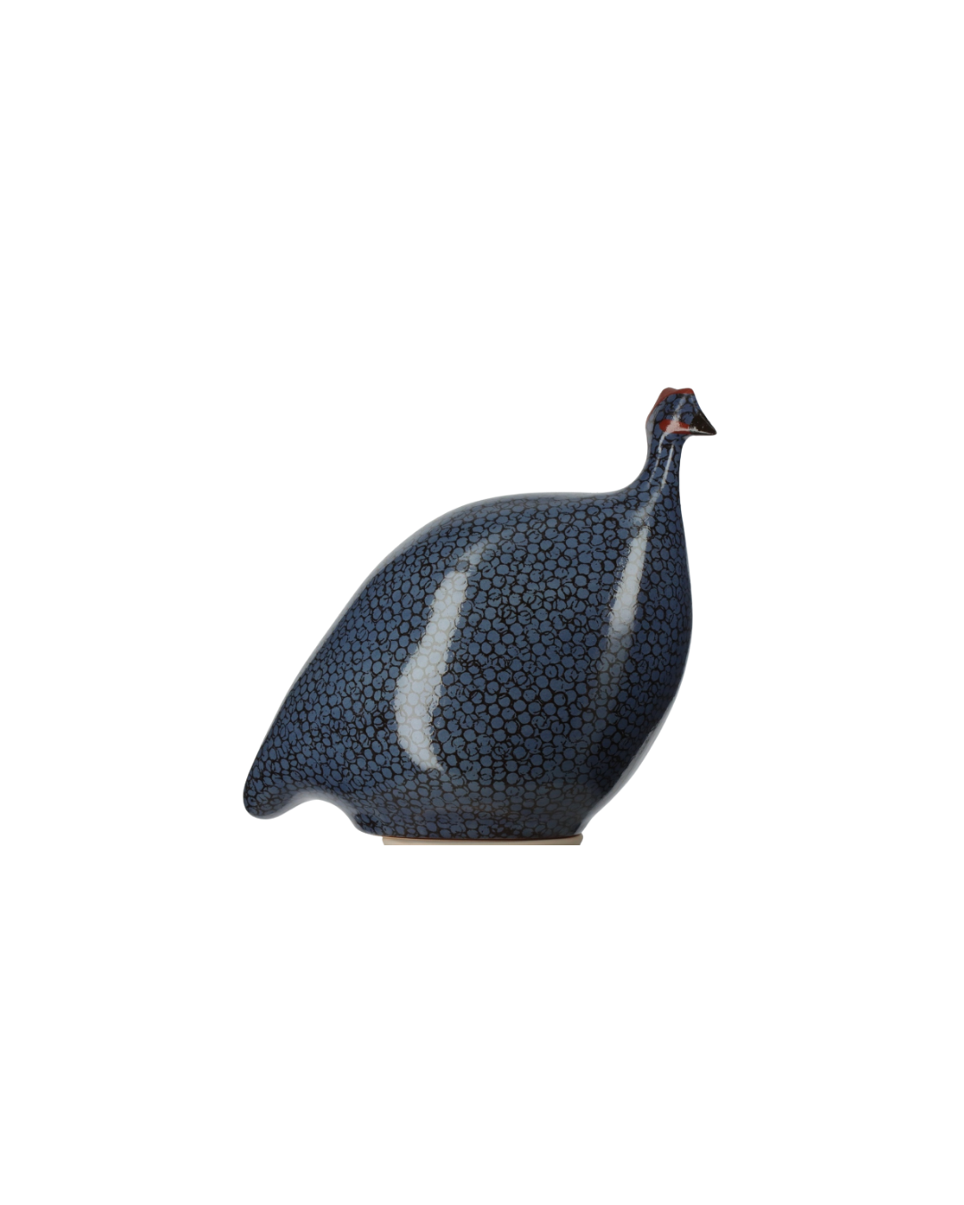 A ceramic decorative figurine of a guinea fowl, featuring a glossy dark blue and black textured pattern with a small red accent on its beak, set against a plain white background.