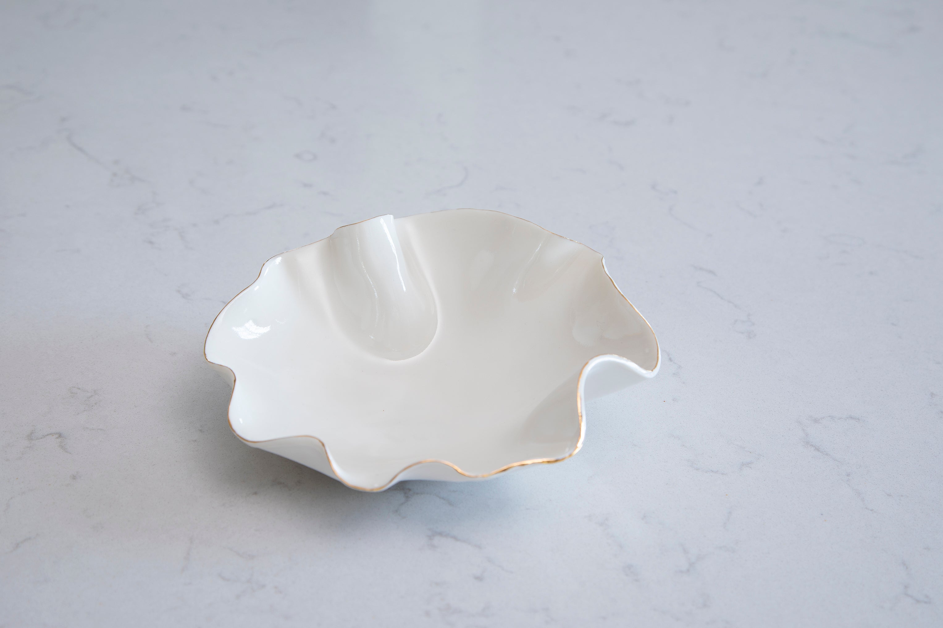 white wave bowl with gold edging