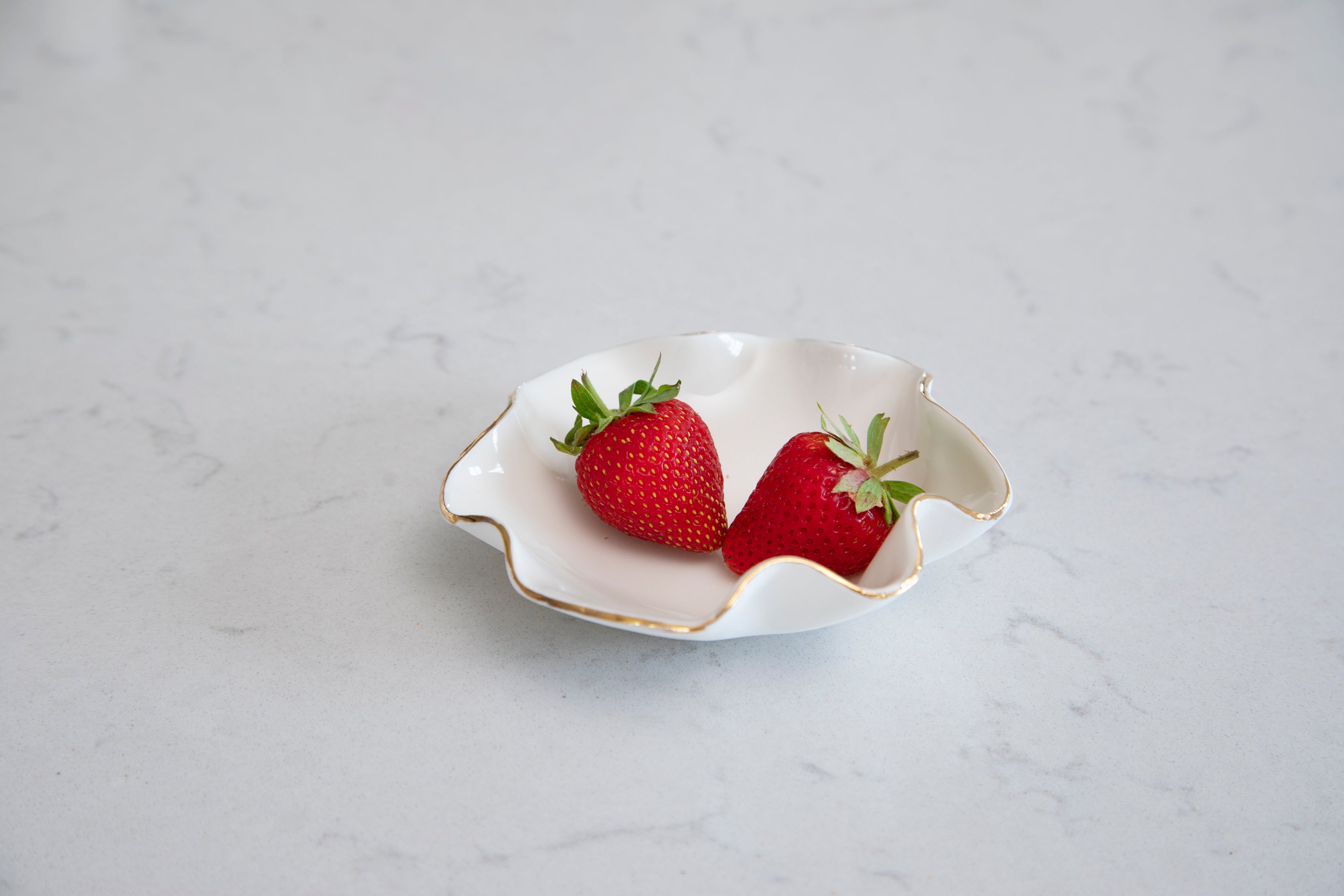 white wave bowl with gold edging